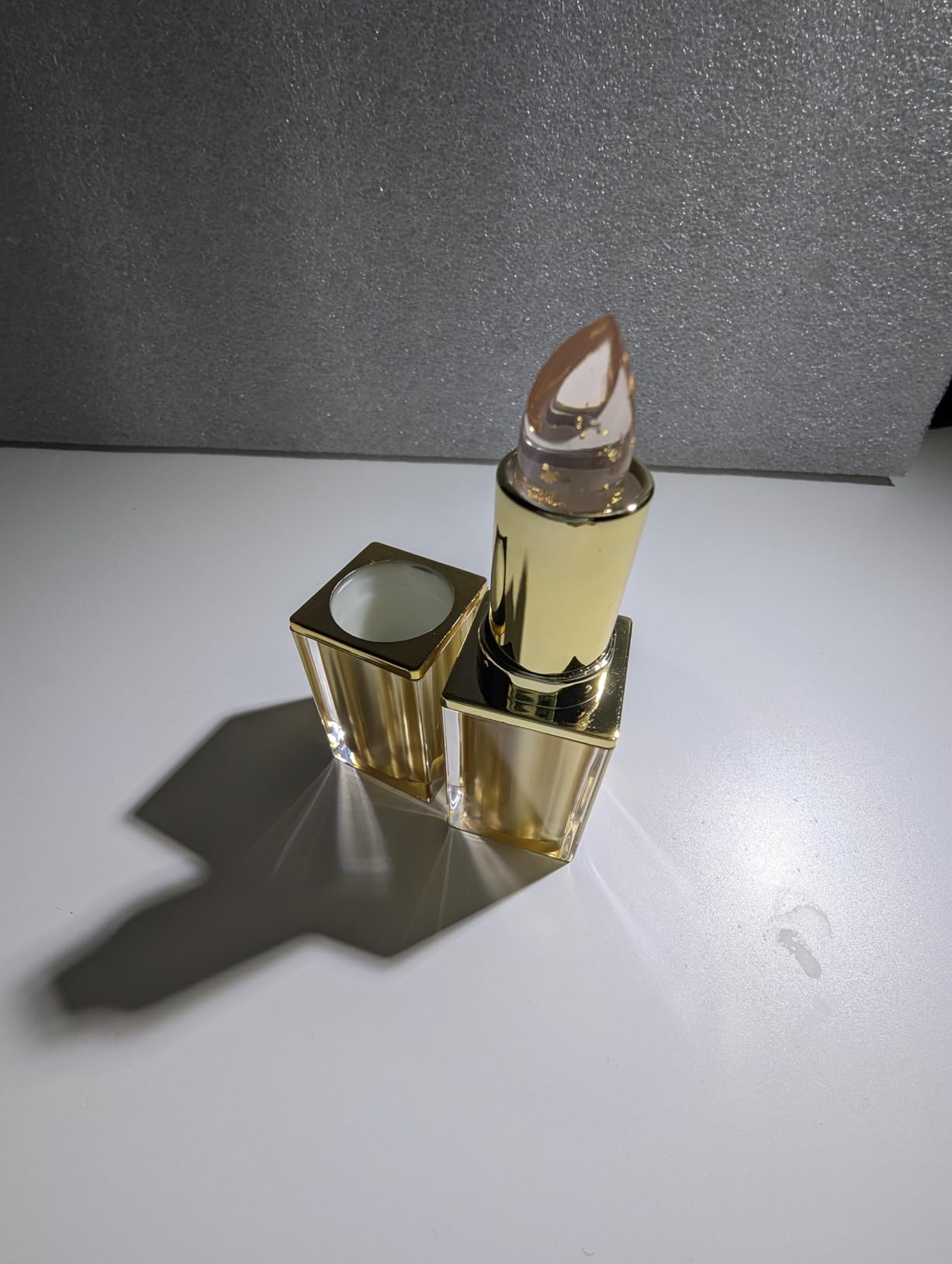Clear lipstick with elegant gold packaging